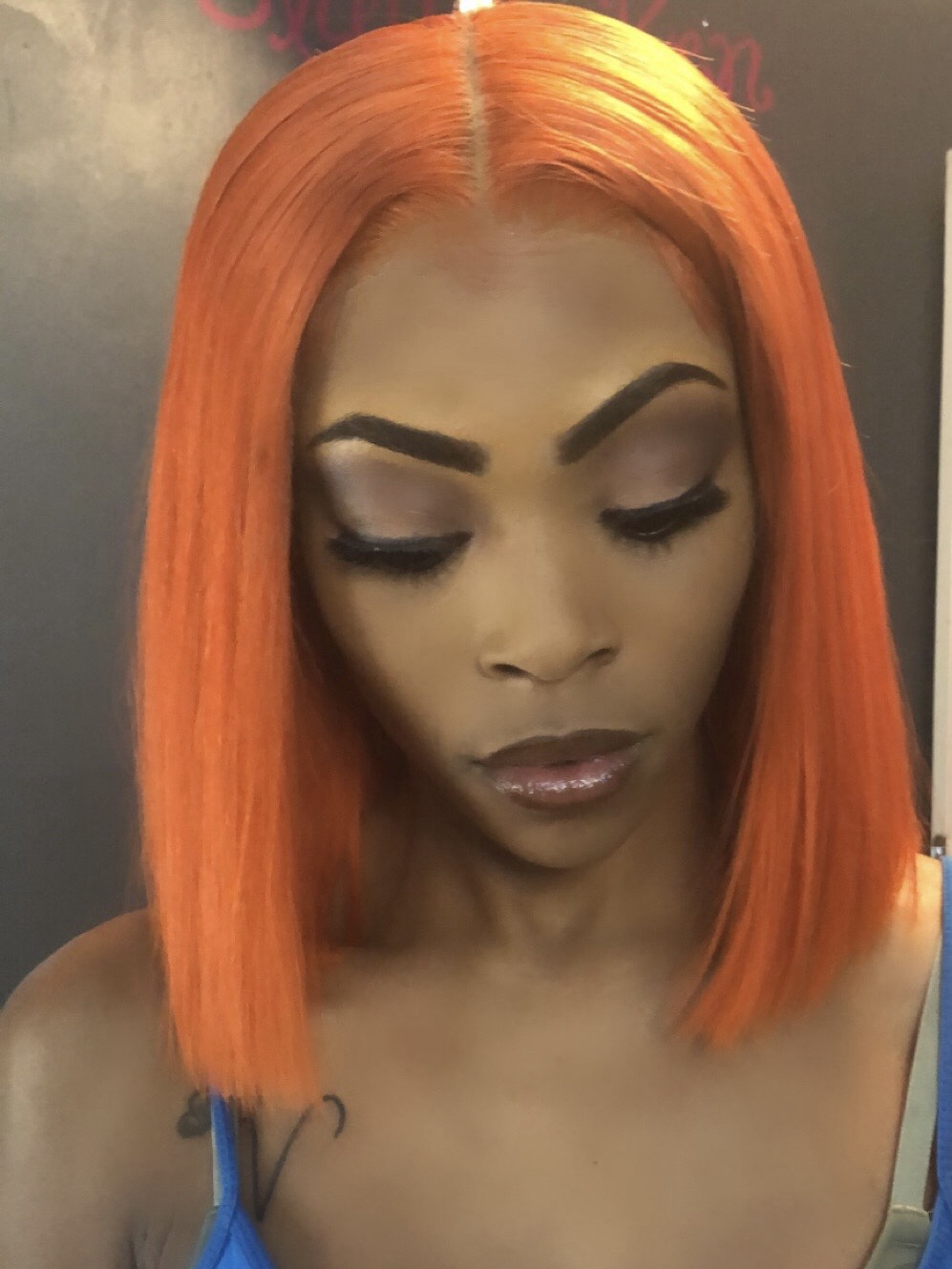 Client with orange bob and soft smoky eye makeup
